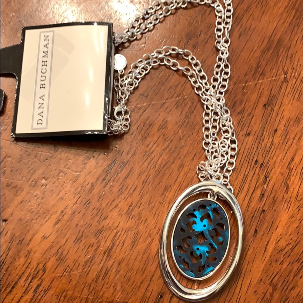 Silver tone necklace with a marble-like charm